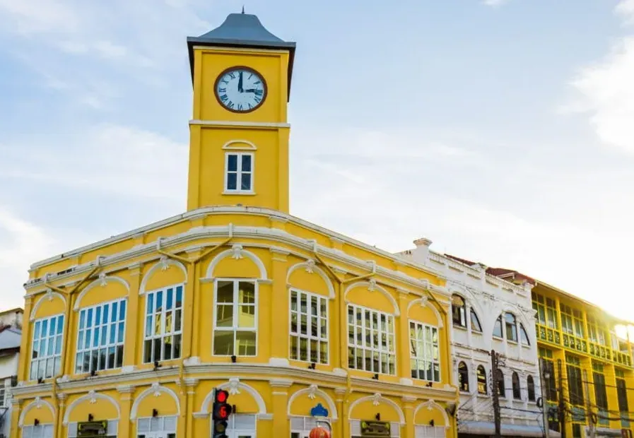 The yellow Sino-Portuguese clock tower on a corner of Phuket Old Town