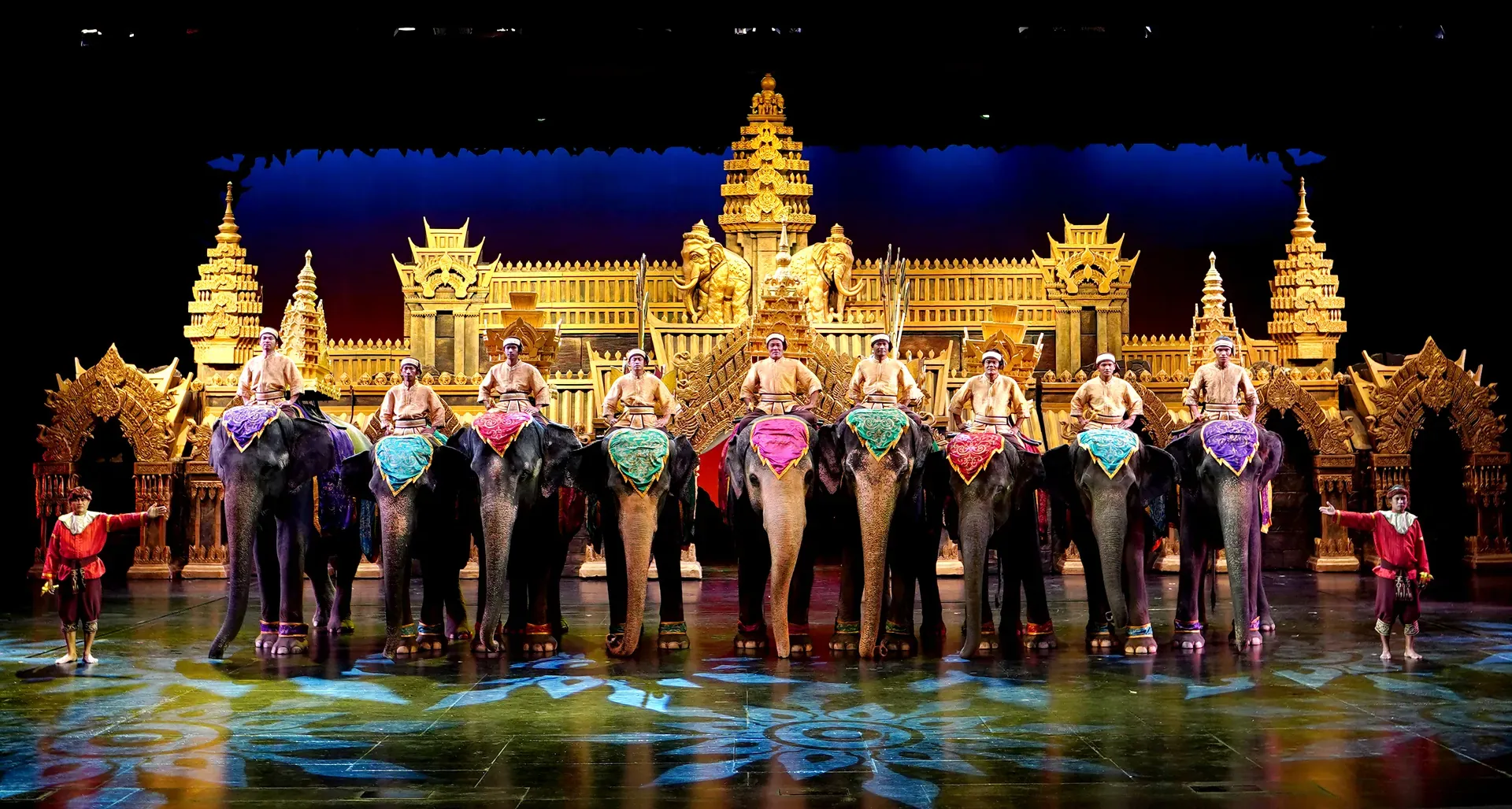 Costumed riders leading decorated elephants across the stage at the Phuket FantaSea show