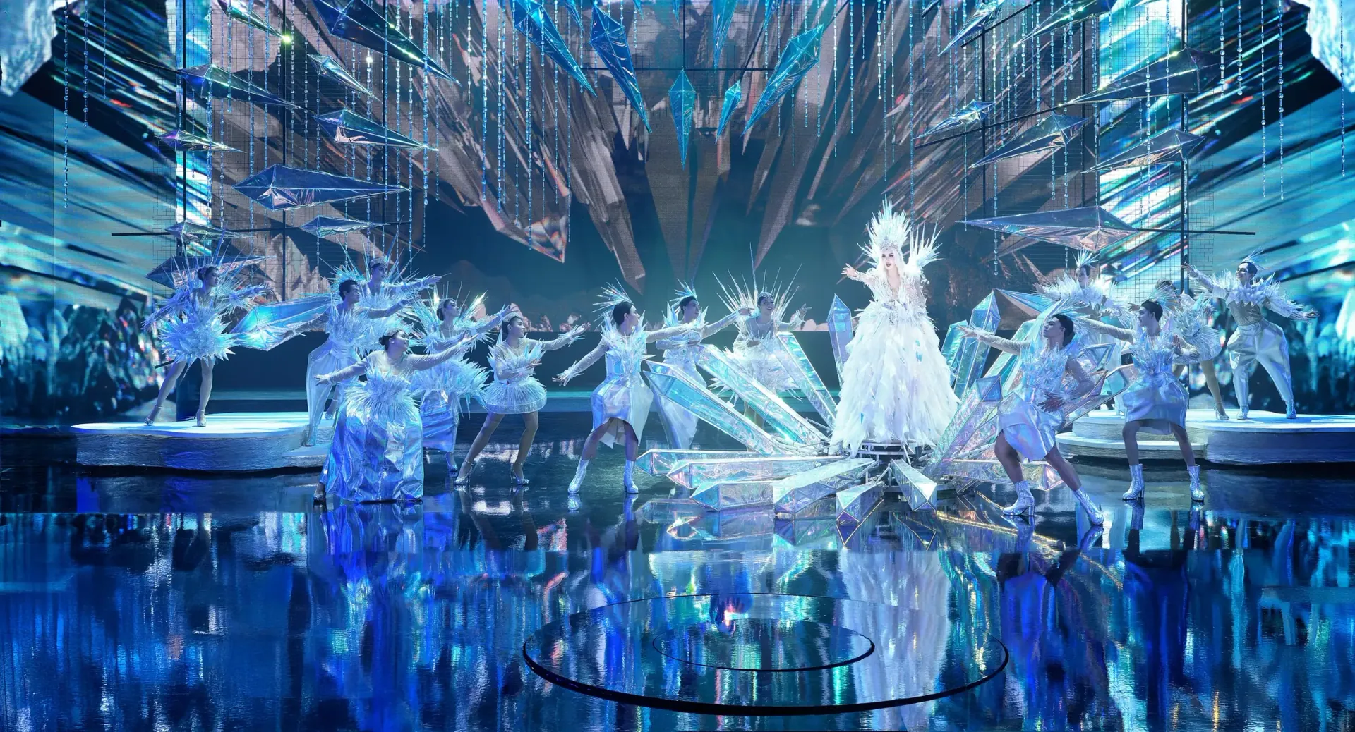 Dancers in crystal costumes under ice-blue light on the stage of Tiffany’s Show in Pattaya